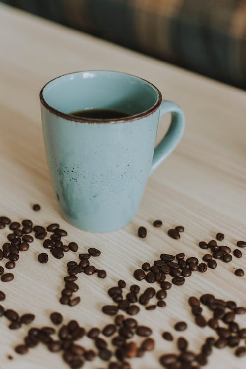 Photo of Mug Near Coffee Beans