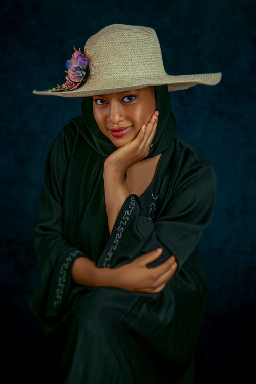 Free Charming portrait of a woman wearing a stylish hat and traditional attire. Stock Photo