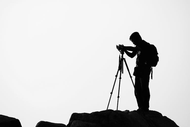 Silhouette Of Man Holding Camera