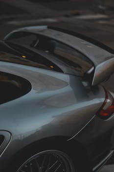 Stylish close-up view of a luxury sports car's rear end with sleek design and spoiler.