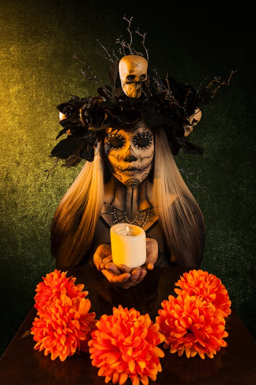 Free A Woman in Catrina Makeup Holding a Candle Stock Photo