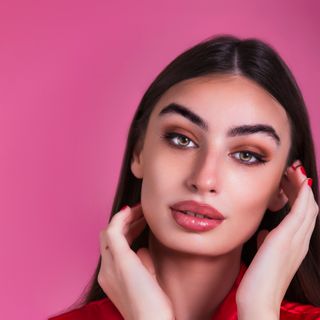 Close-up portrait of a member against a pink backdrop — photo by Carlos GUTIERREZ on Pexels