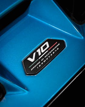Detailed view of a V10 engine badge on a sleek blue car surface.