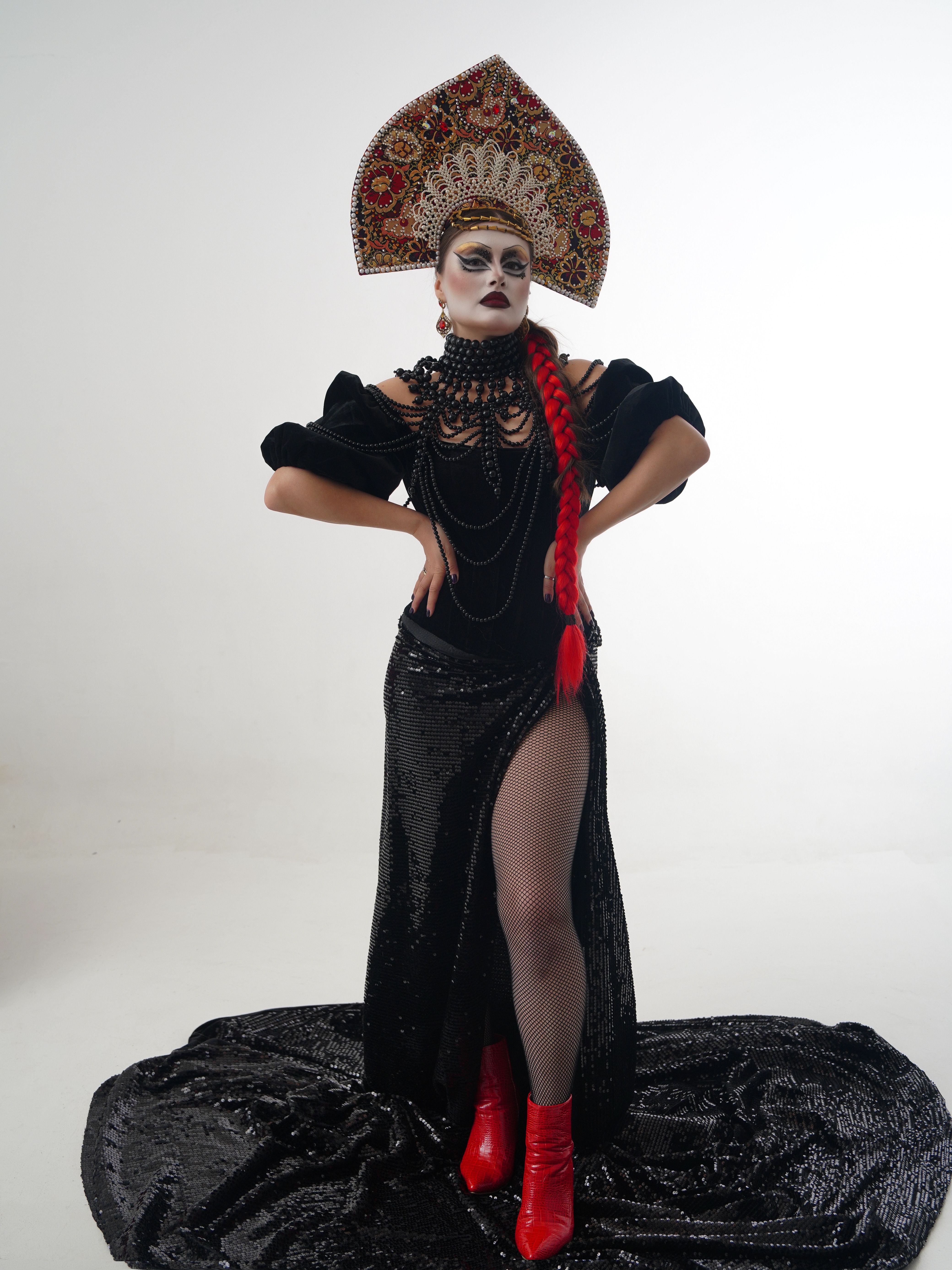 Portrait of a woman in avant-garde fashion with elaborate headdress and costume.