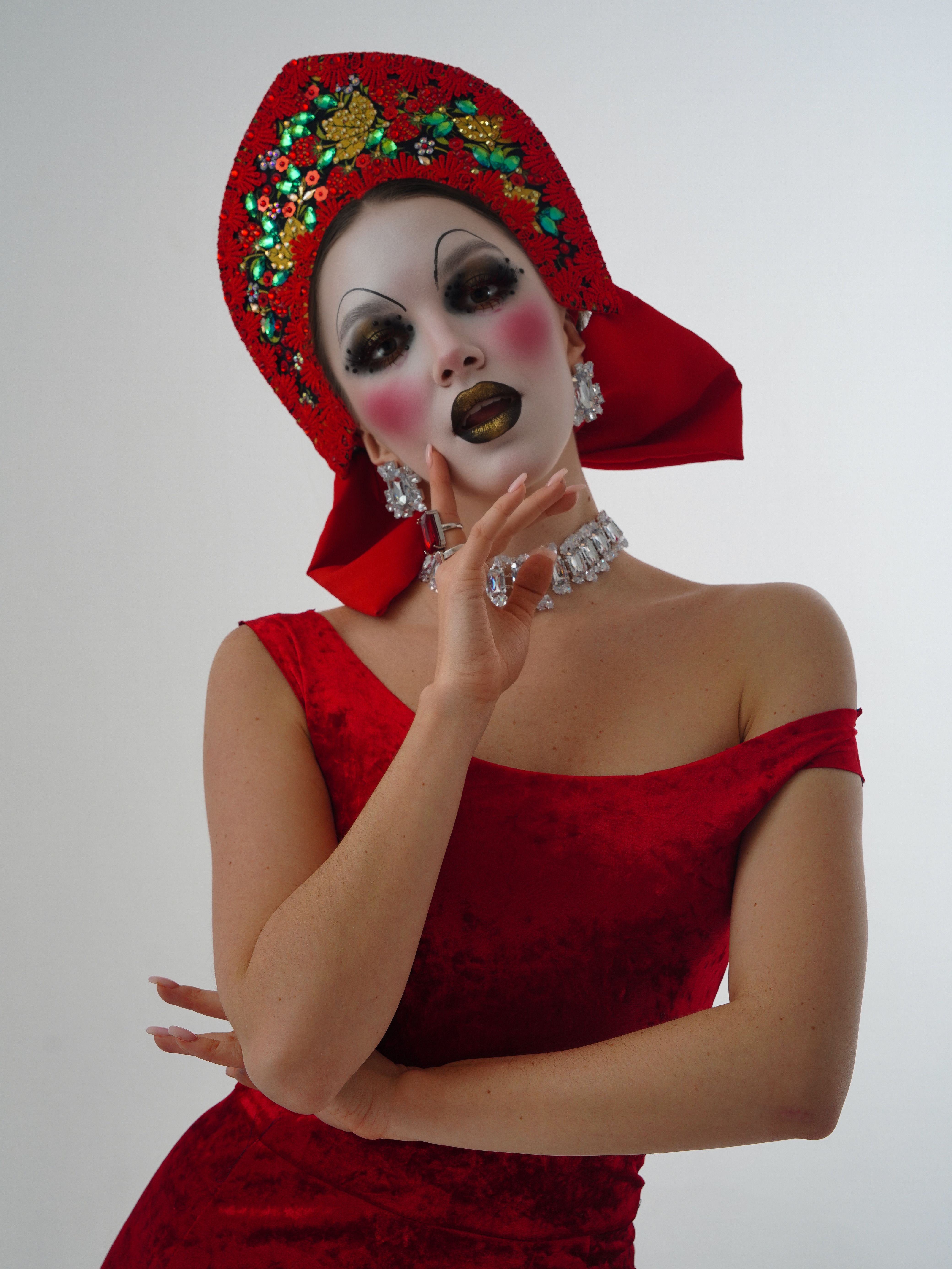 Dramatic portrait of a woman in a colorful costume with expressive makeup. Perfect for creative themes.