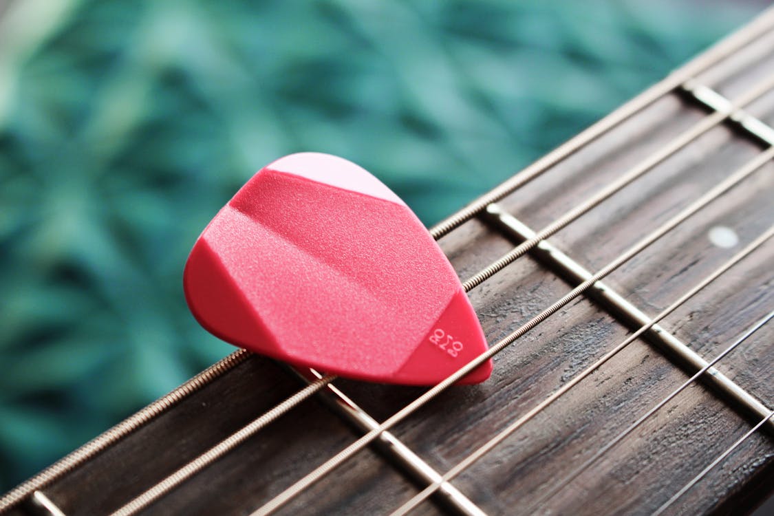 Close-Up Photo of Red Guitar Pick