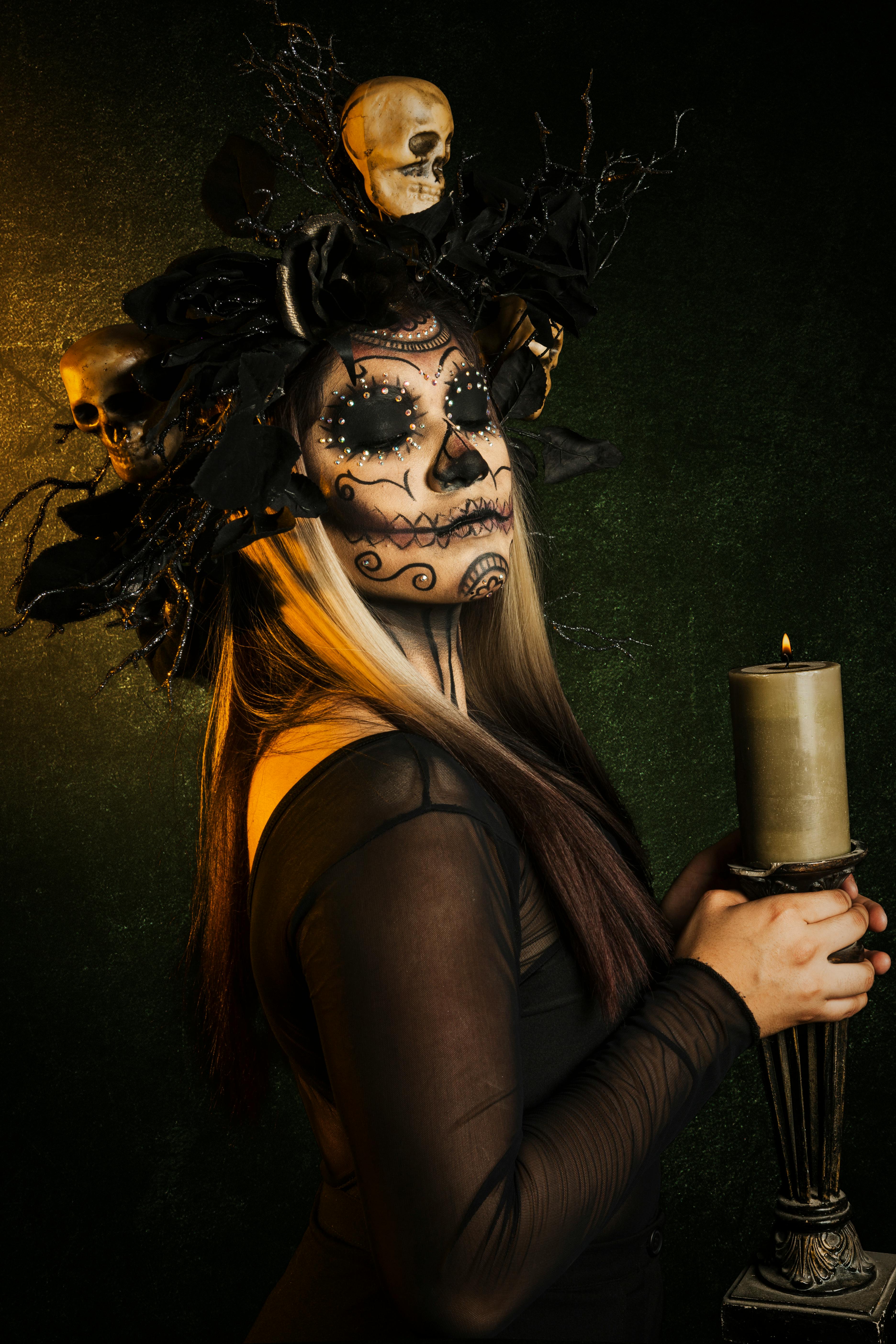 Premium Photo  Halloween costume and makeup portrait of catrina with hands  of fire