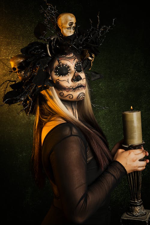 A Woman in Catrina Makeup Holding a Candle