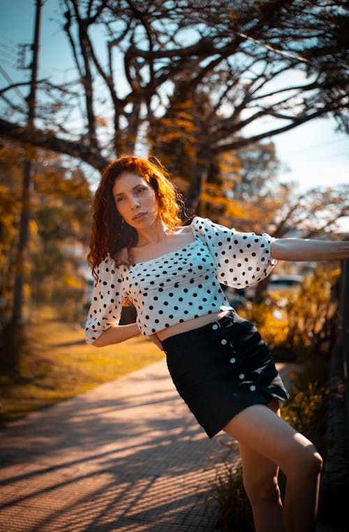 Photo of Woman Wearing Polka Dots Blouse and Skirt