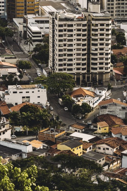 Free Aerial view of a residential neighborhood with a prominent high-rise building. Stock Photo