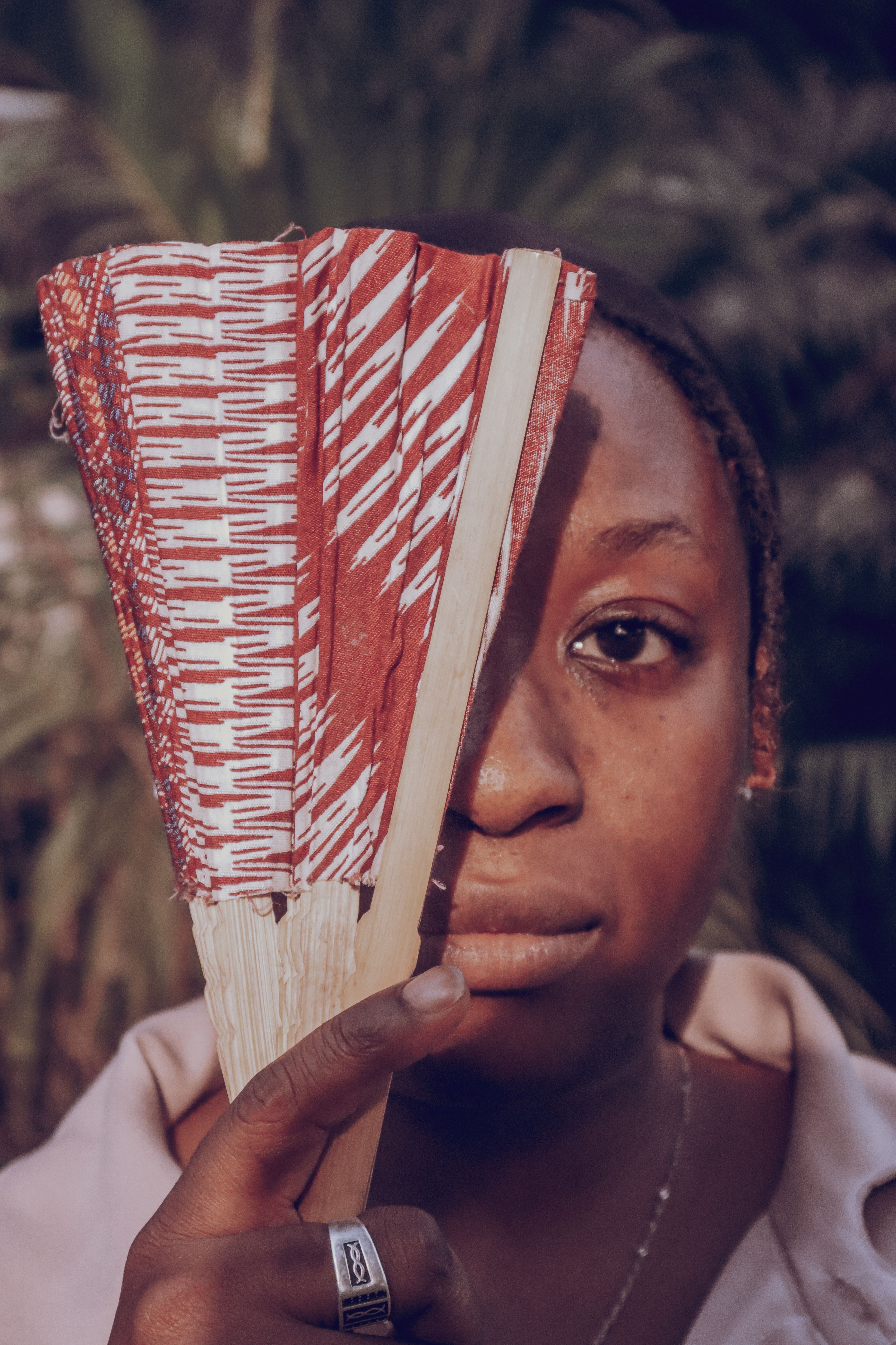 Artistic portrait with traditional fan, Sierra Leone
