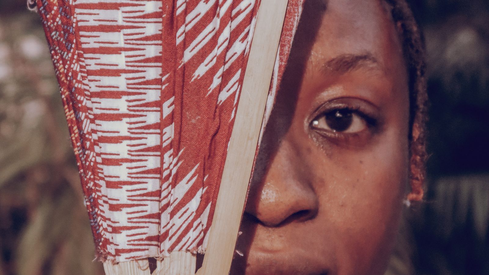 Artistic portrait with traditional fan, Sierra Leone