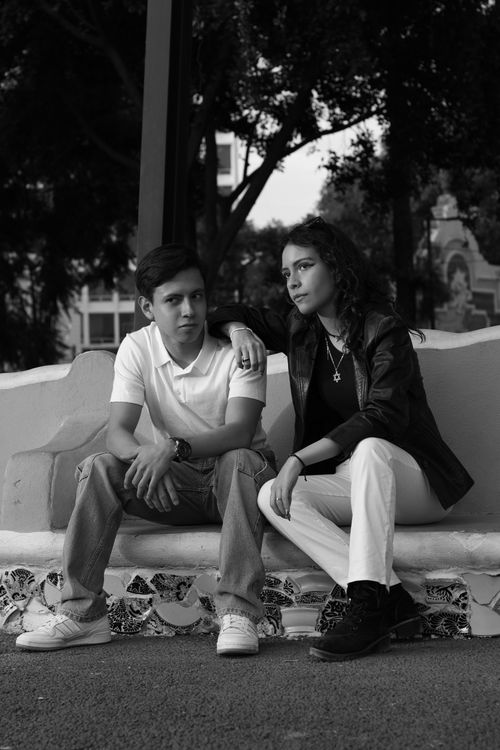 Free Monochrome portrait of a young couple sitting in a city park. Stock Photo