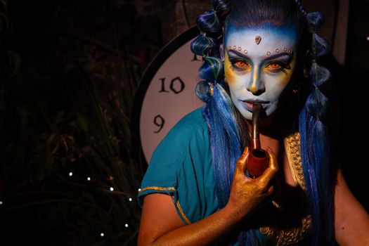 Captivating cosplay with blue makeup and ornate costume evokes a fantasy world with a mystical vibe.