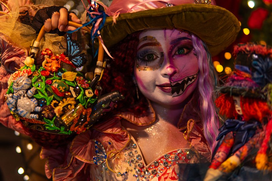 Enchanting Alice in Wonderland-inspired cosplay featuring vivid costumes and artistic makeup.
