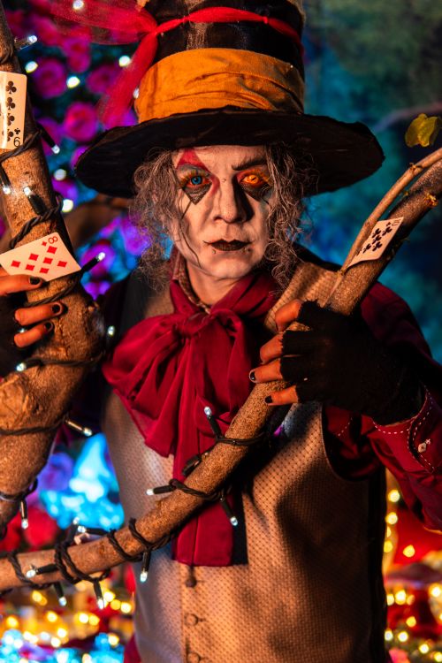 Free Colorful Mad Hatter cosplay with vivid costume in Wonderland-inspired backdrop. Stock Photo