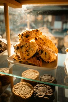 A tempting assortment of cookies arranged attractively under warm lighting.