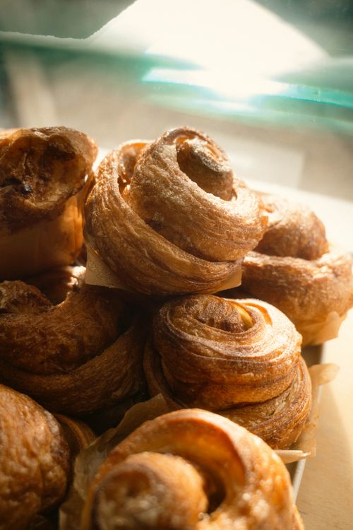 Free Delicious freshly baked croissants in warm sunlight, perfect for a cozy morning. Stock Photo
