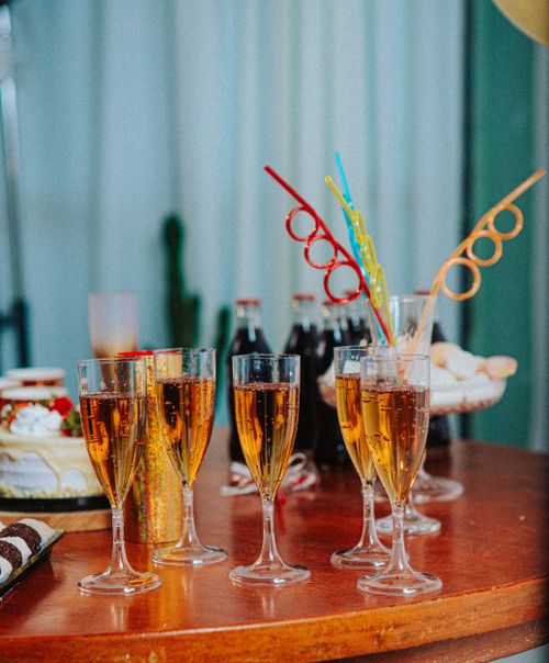 Free Lively party setup with sparkling drinks and snacks on a wooden table. Stock Photo