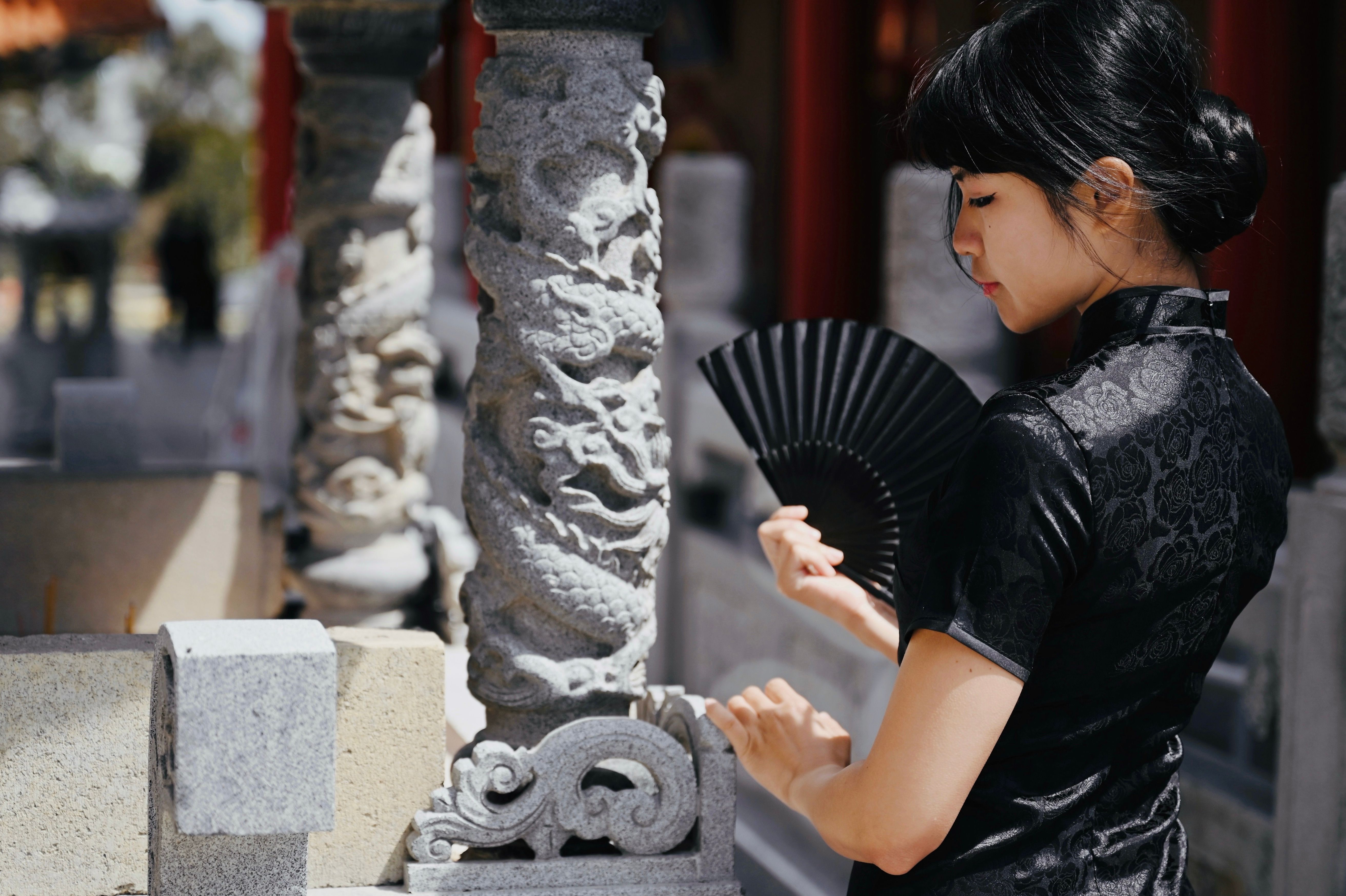 Elegant Woman with Fan in Traditional Dress · Free Stock Photo
