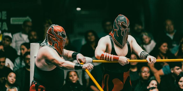 Wrestlers grappling inside a lit ring — photo by Amar Preciado on Pexels