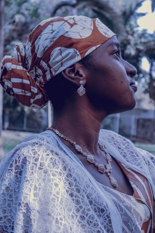 Free Side profile of a woman in traditional attire with intricate jewelry outdoors. Stock Photo