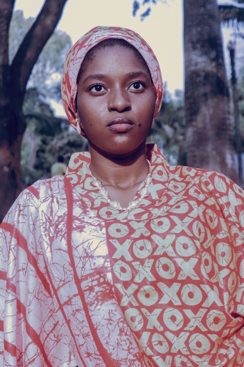 Free Confident woman in colorful traditional African dress outdoors. Stock Photo