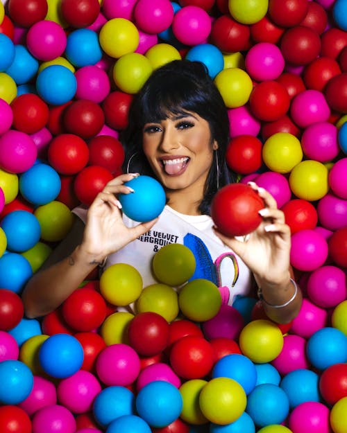 Photo of Woman Surrounded by Multicolored Balls