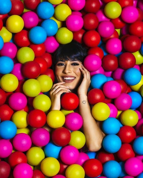 Photo of Woman Covered With Multicolored Balls