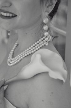 Black and white bridal portrait featuring pearls and calla lily.