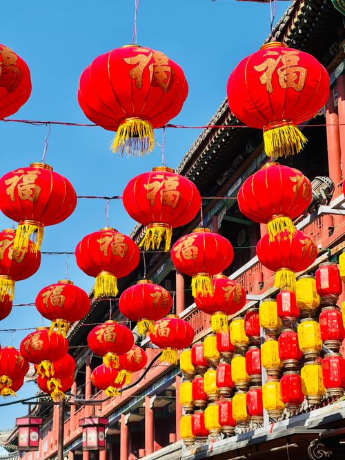 Free Bright red Chinese lanterns adorn a festive street, symbolizing celebration. Stock Photo