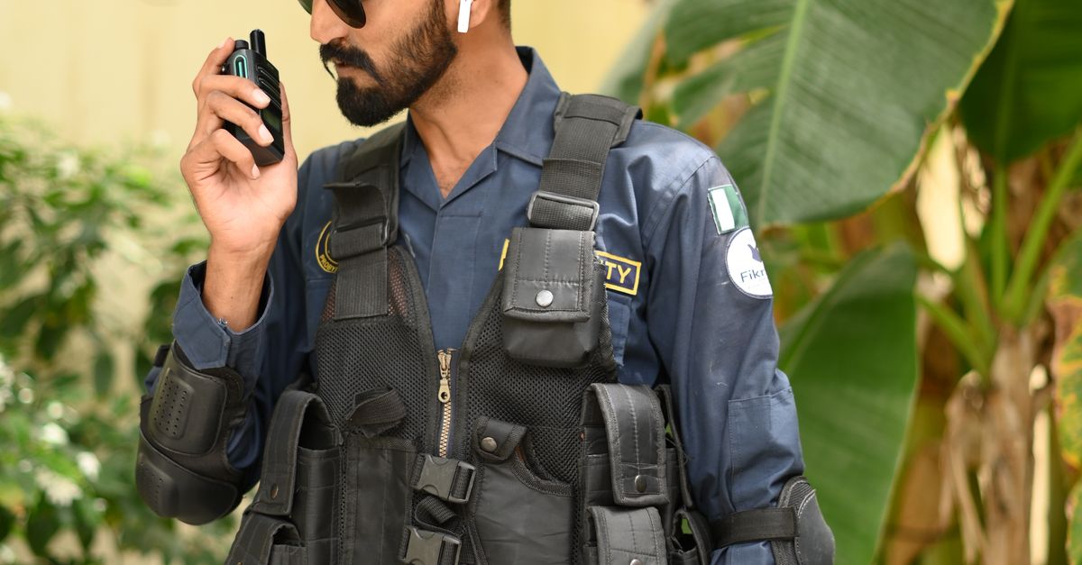 Security Guard Texting Security Guard Communicating via Walkie Talkie ยท Free Stock Photo