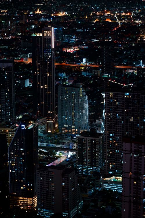 Free Stunning night view of Bangkok's illuminated cityscape with towering skyscrapers and vibrant lights. Stock Photo