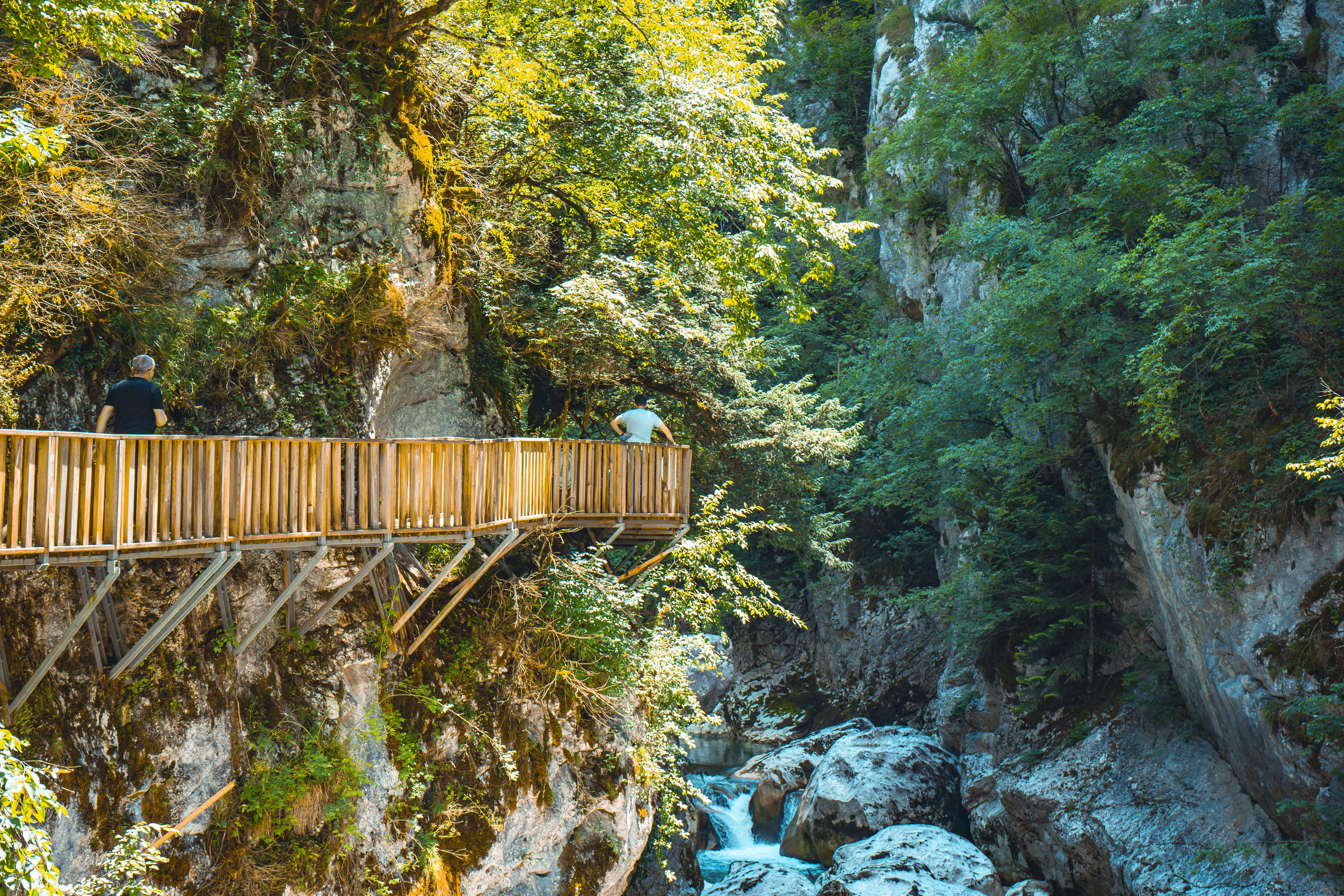 Hikers on a wooden ladder in Suchá Belá Gorge, Slovak Paradise National Park, Slovakia.