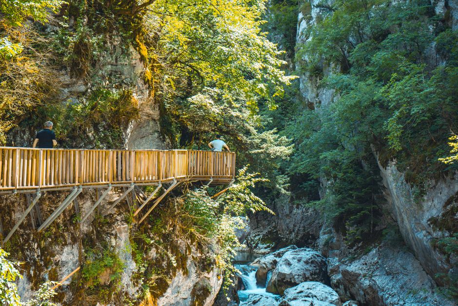 Hikers on a wooden ladder in Suchá Belá Gorge, Slovak Paradise National Park, Slovakia.