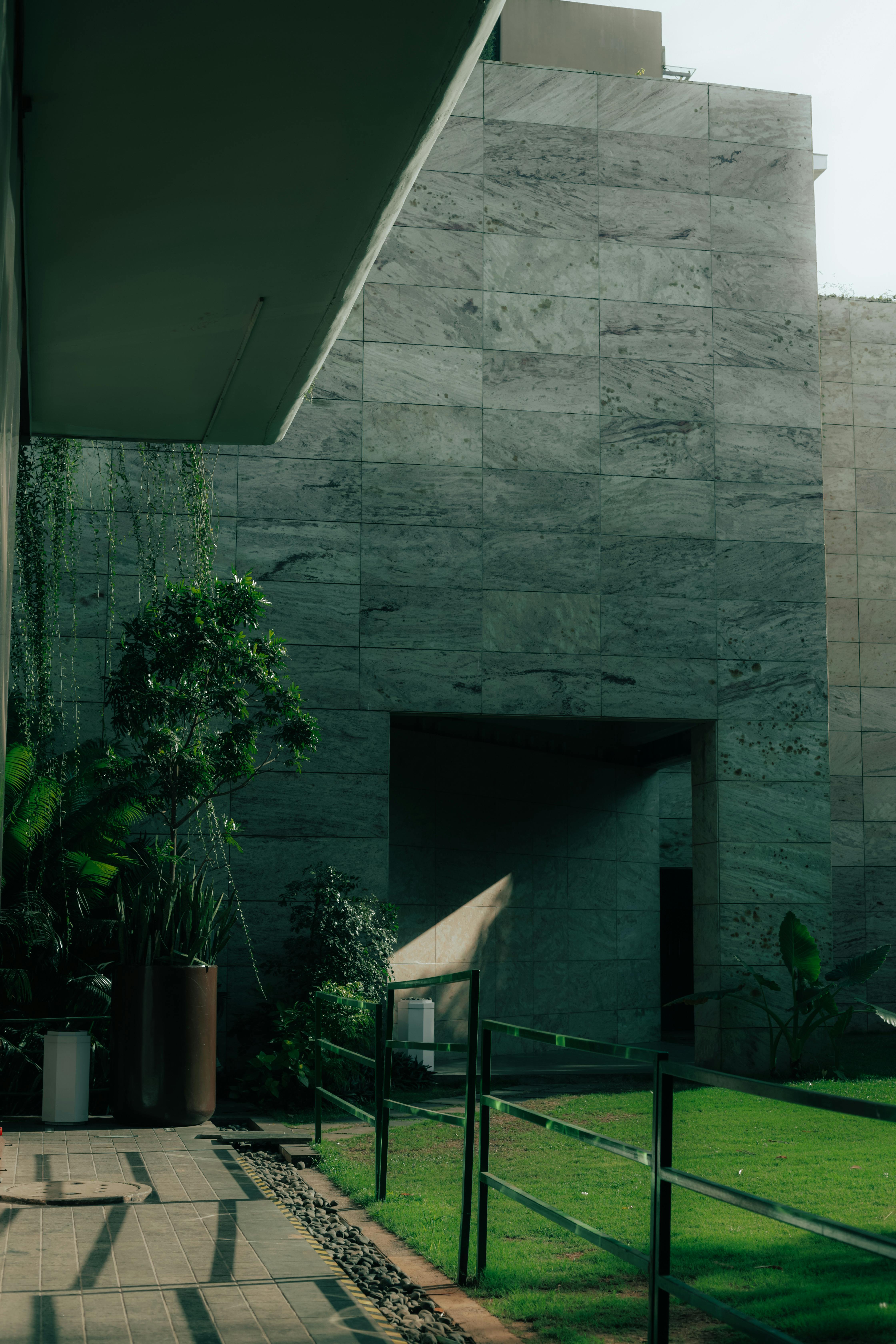 Contemporary architectural structure with lush greenery in GA, India, showcasing modern design.