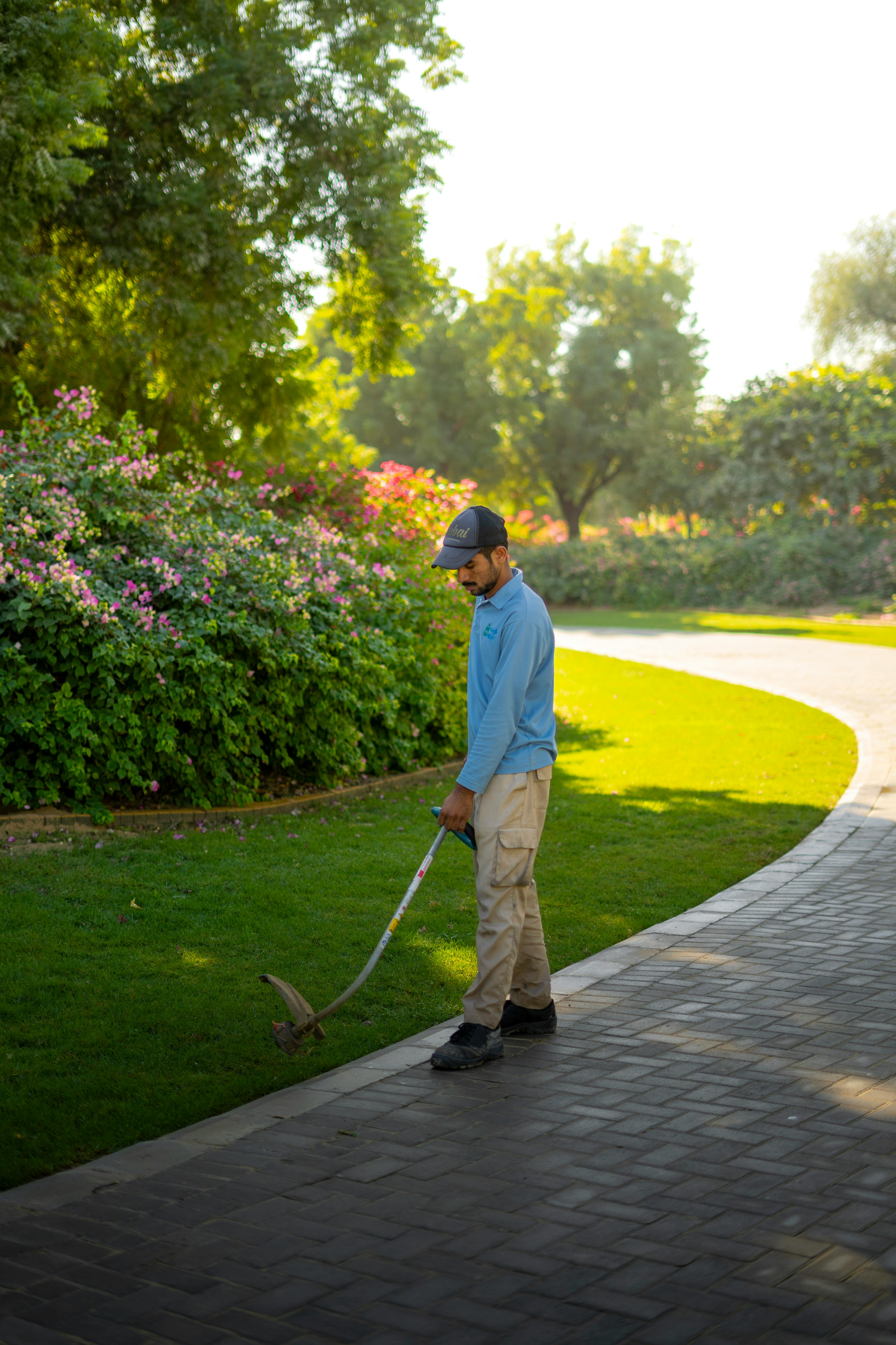 Landscaper maintaining a tidy garden area