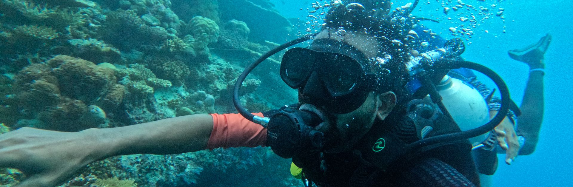 Experience scuba diving among vibrant corals in the Maldives underwater paradise.
