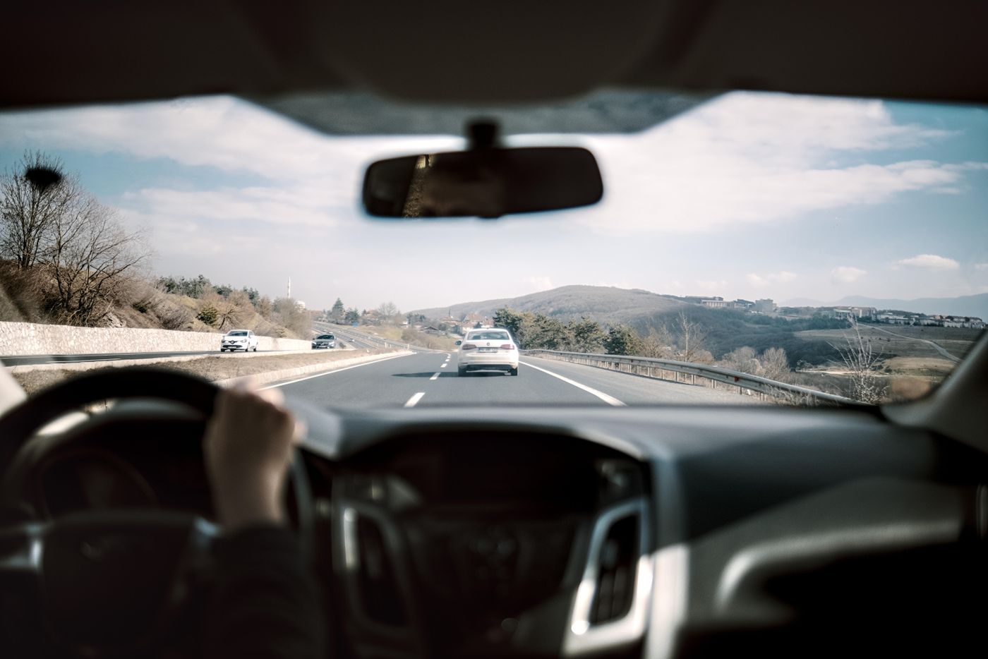 Scenic road viewed through a car windscreen during a road trip