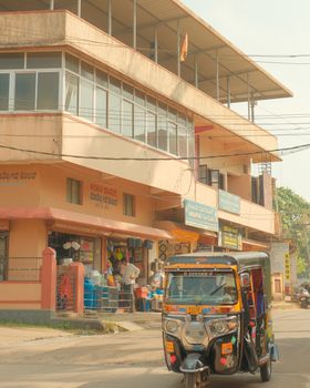 Auto rickshaw on a busy street in Karkala, Karnataka, India.
