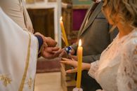 Close-up of traditional Serbian Orthodox wedding with candle lighting ritual.