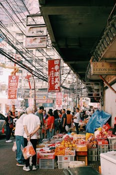 A vibrant street market scene with diverse shoppers and colorful stalls in a busy city.