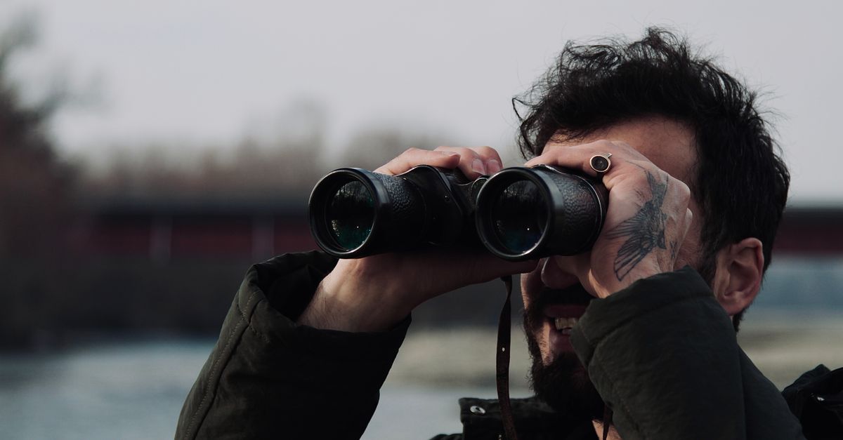 Male Observer Man Observing with Binoculars by the River · Free Stock Photo