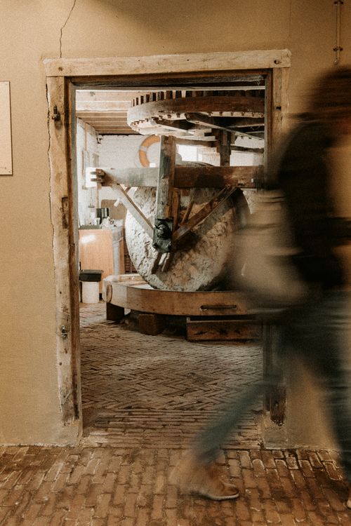 Free Historic mill interior captured with a vintage look and motion blur of a passing person. Stock Photo