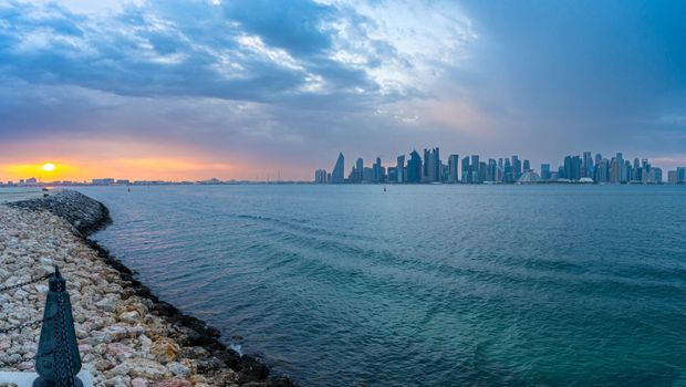 Breathtaking sunset over Doha's skyline as seen from the waterfront, Qatar.