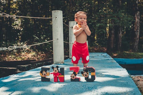 Little Boy Wearing Red Shorts