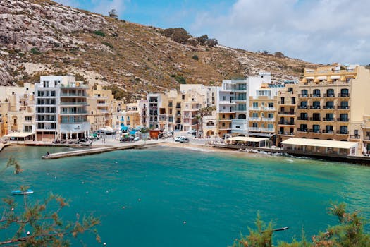 Picturesque coastal village in Malta with azure waters and scenic architecture.