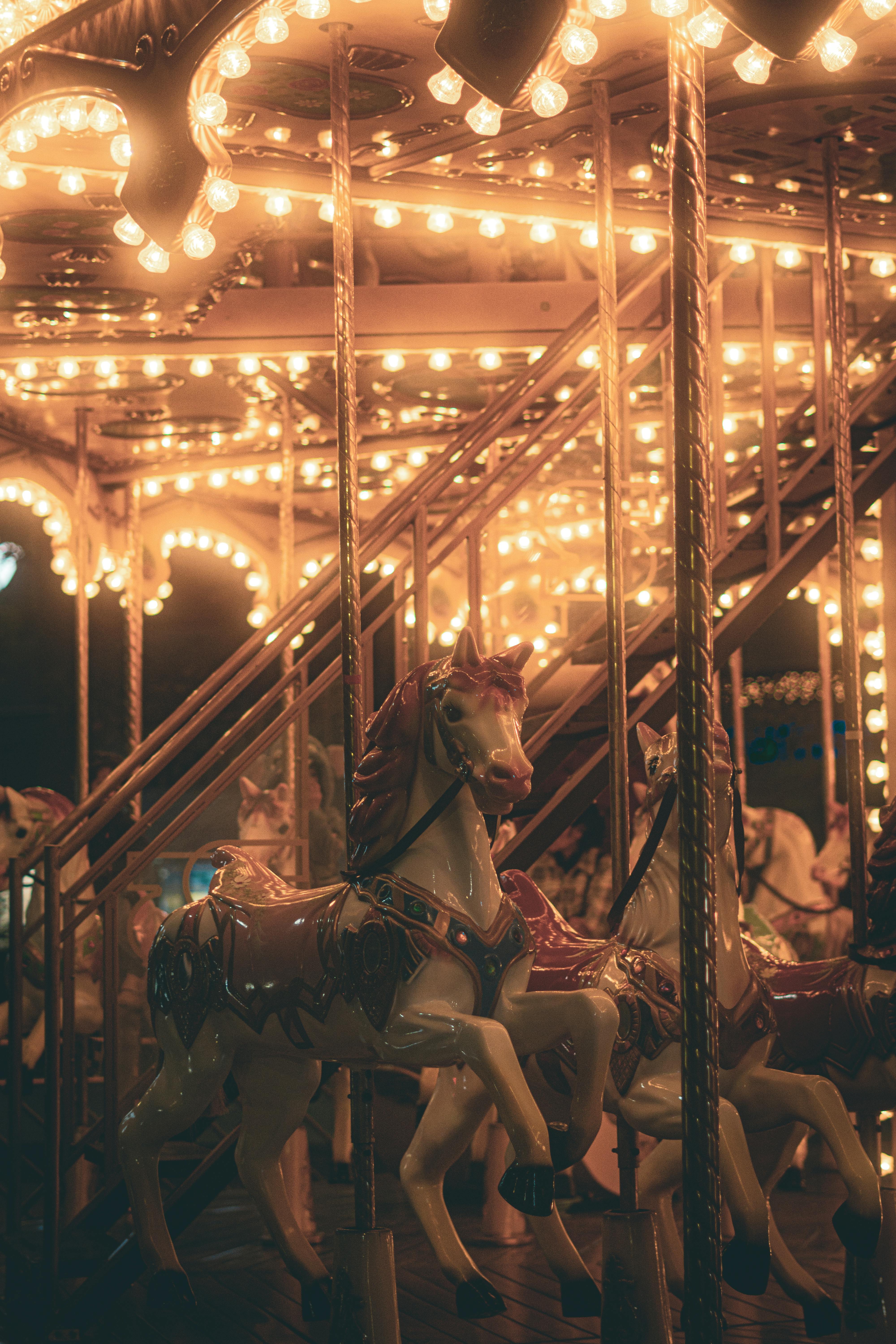 vintage carousel at night with illuminated horses