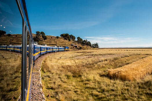 Beautiful train ride through the rural landscapes of Puno, Perú with golden fields and blue skies.