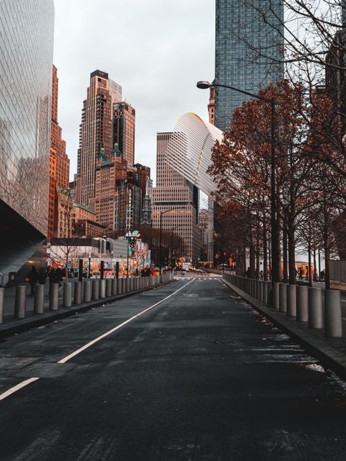 Free Empty street leading to iconic New York City skyscrapers in fall. Stock Photo